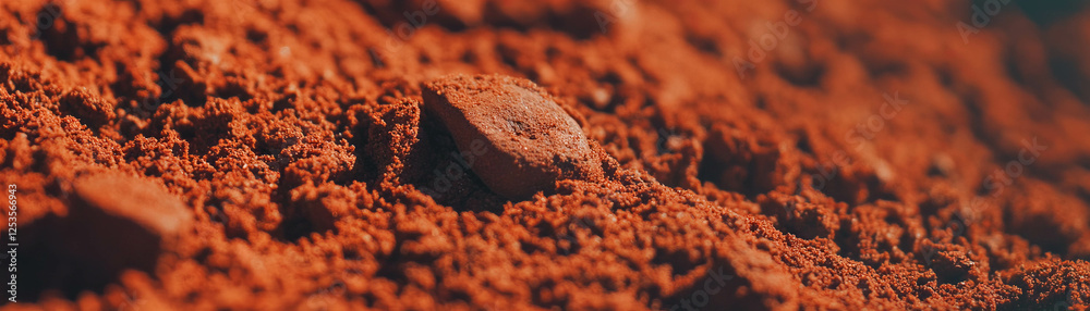 Close-up view of coffee grounds showcasing fine texture and rich colors against a bright background Close-up view of coffee grounds showcasing fine texture and rich colors against a bright background