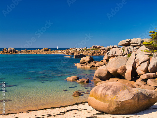 Rock formations on the famous Pink Granite Coast near Ploumanac'h in Perros-Guirec, Lannion, Brittany in Northern France. Taken on a sunny day in summer, with a blue sky and light cloud.