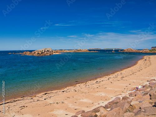 Rock formations on the famous Pink Granite Coast near Ploumanac'h in Perros-Guirec, Lannion, Brittany in Northern France. Taken on a sunny day in summer, with a blue sky and light cloud.