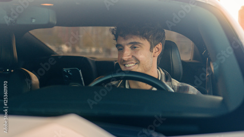 Happy smiling business man using phone apps in car urban driving lifestyle with mobile app technology smartphone in auto gps navigation. Cheerful male guy driver automobile waiting in city traffic jam