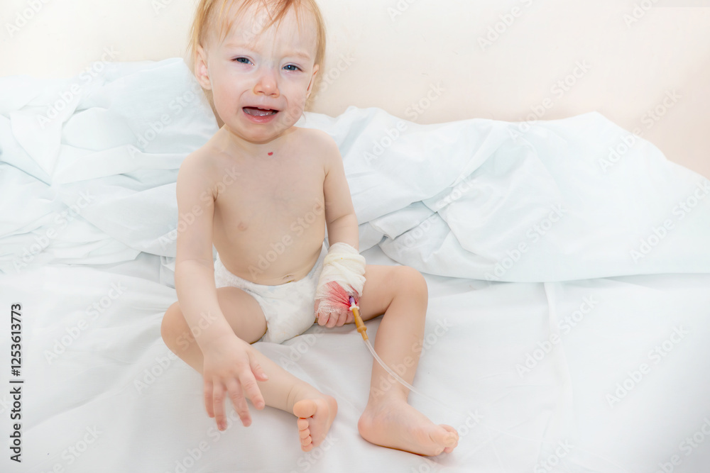 Children illness . Little Baby attaching intravenous tube to patient's hand in hospital bed. Baby sick and crying and baby want mom