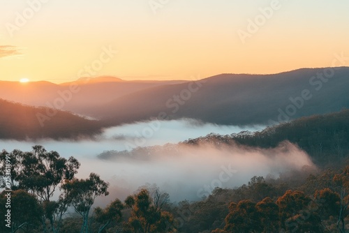 Serene Sunrise Over Misty Mountains and Valleys with Soft Light and Warm Colors
