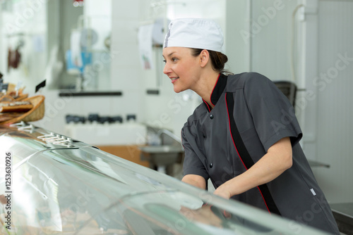 smiling woman selling gifts of fine chocolates and confectionery photo