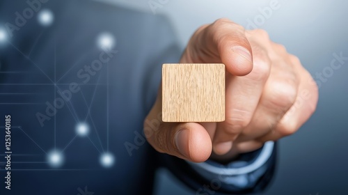 Hand holding wooden cube, building blocks for construction, architecture, design, games, and educational play photo