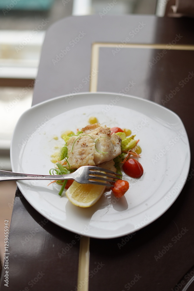 Elegant Fish Dish with Salad and Tomatoes Elegant Fish Dish with Salad and Tomatoes
