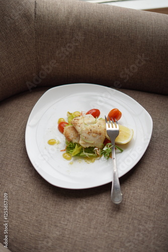 Plated Salmon Fish Dish with Salad and Lemon Garnish
