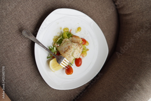 Plated Salmon Fish Dish with Salad and Lemon Garnish