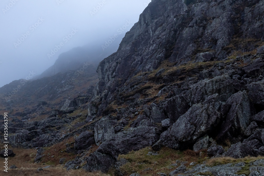 Fototapeta premium Rock on mountainside in Moelwyn range in misty weather
