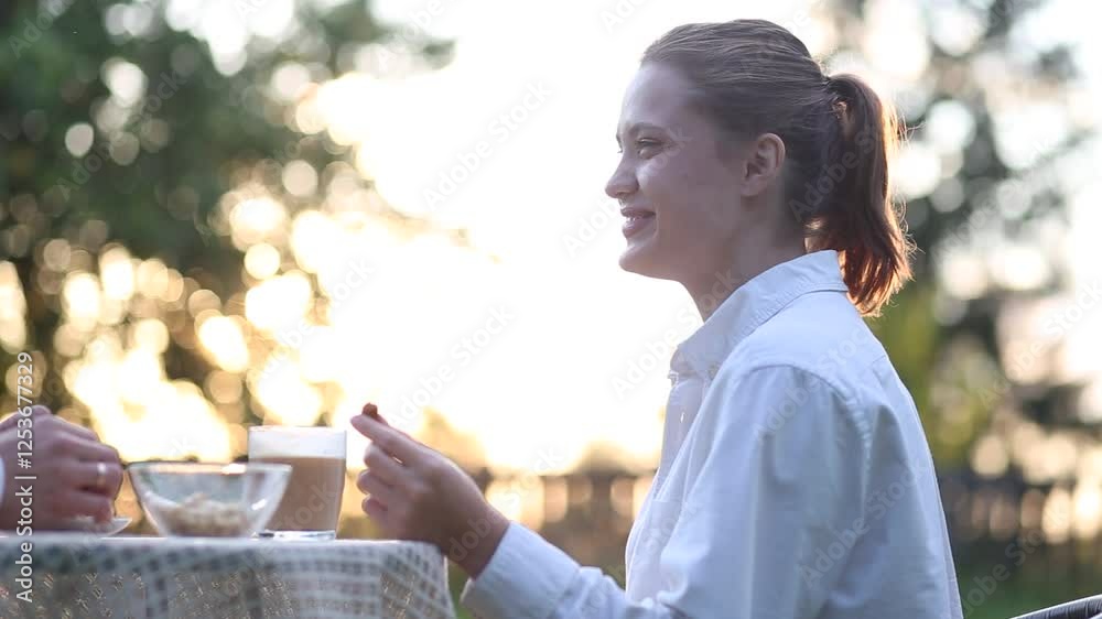 woman eating chocolate in the garden in summer woman eating chocolate in the garden in summer