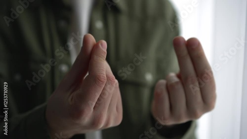 A man shows with his hands that he needs money.
A man demands a salary increase.
Businessman showing finance and money gesture
