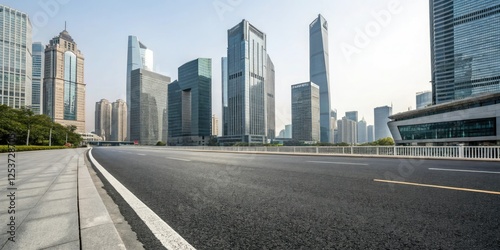 Wide asphalt road stretching through a modern cityscape with sleek skyscrapers and glass towers in the background, cityscape, modern city