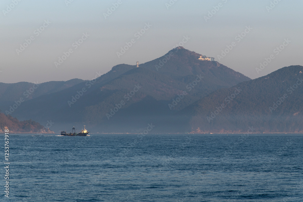 fishing boat with fog on the sea at dawn fishing boat with fog on the sea at dawn