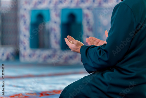A captivating image of an imam praying after praying and reciting the Quran in a tranquil mosque, capturing the essence of faith and devotion.