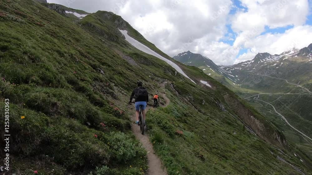 Secured to the rock face, a climber tackles the vertical challenge of Via Ferrata Corno del Bene, with a lush valley far below. Secured to the rock face, a climber tackles the vertical challenge of Via Ferrata Corno del Bene, with a lush valley far below.