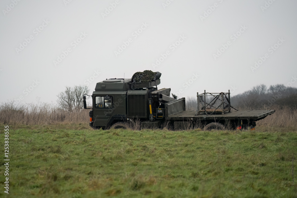 Naklejka premium British army MAN SV 4x4 logistics truck driving an unmade road