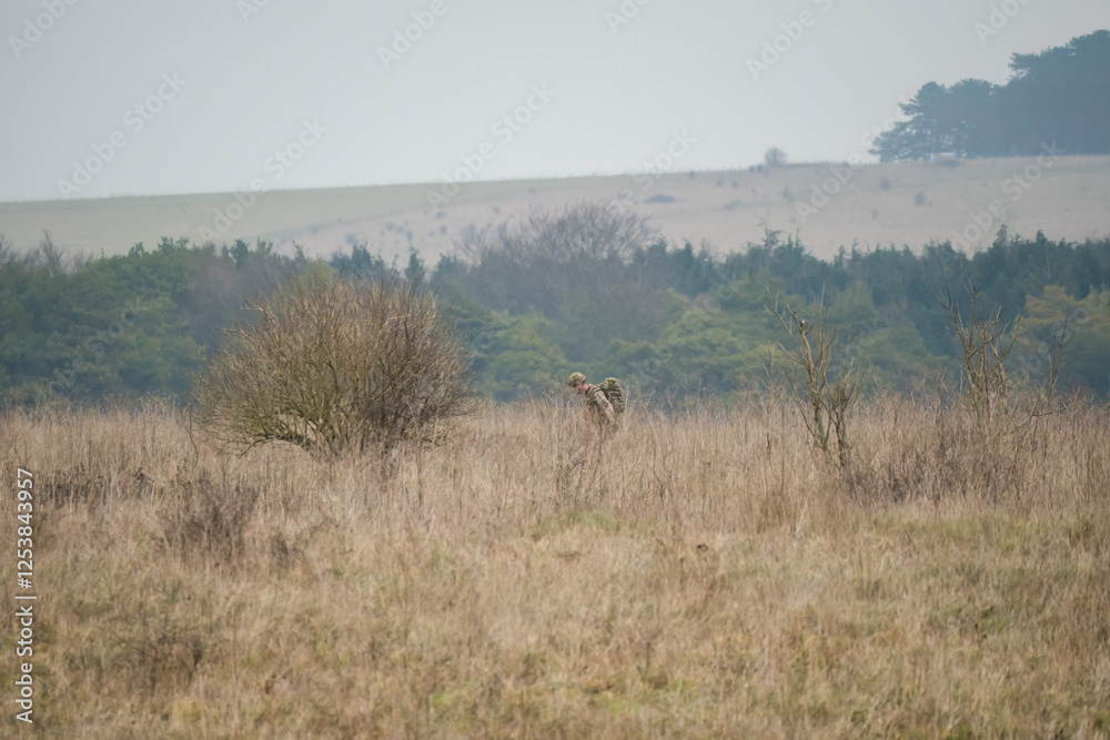 British army soldier on a tabbing exercise bearing full 40Kg bergen