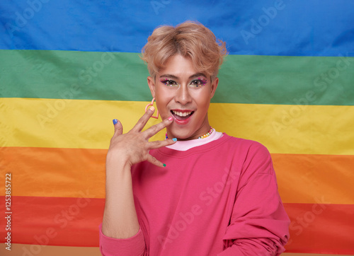 Youth asian transgender LGBT with Rainbow flag background. Man with a gay pride flag concept.