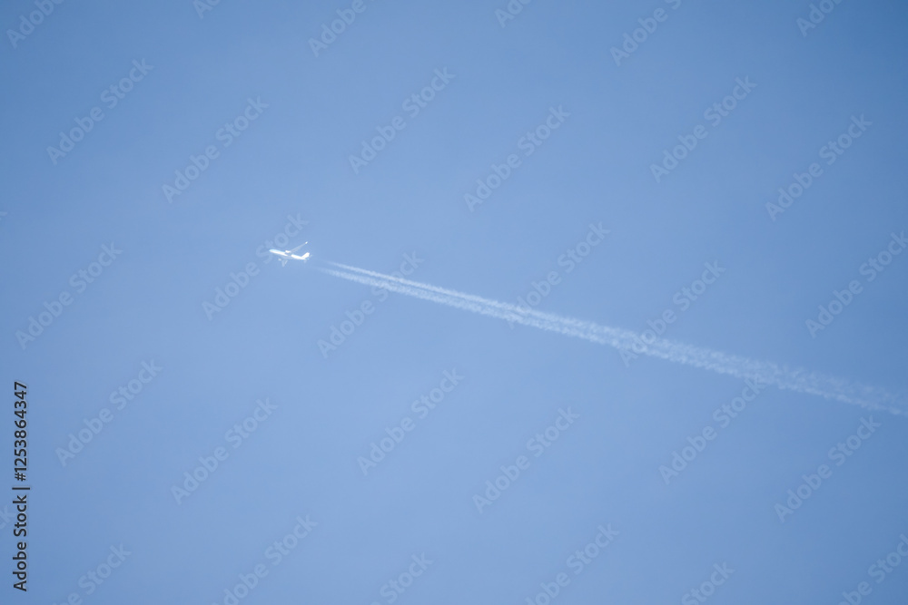 high altitude twin engine contrails (jet airplane vapour trails) across a deep blue clear sky high altitude twin engine contrails (jet airplane vapour trails) across a deep blue clear sky