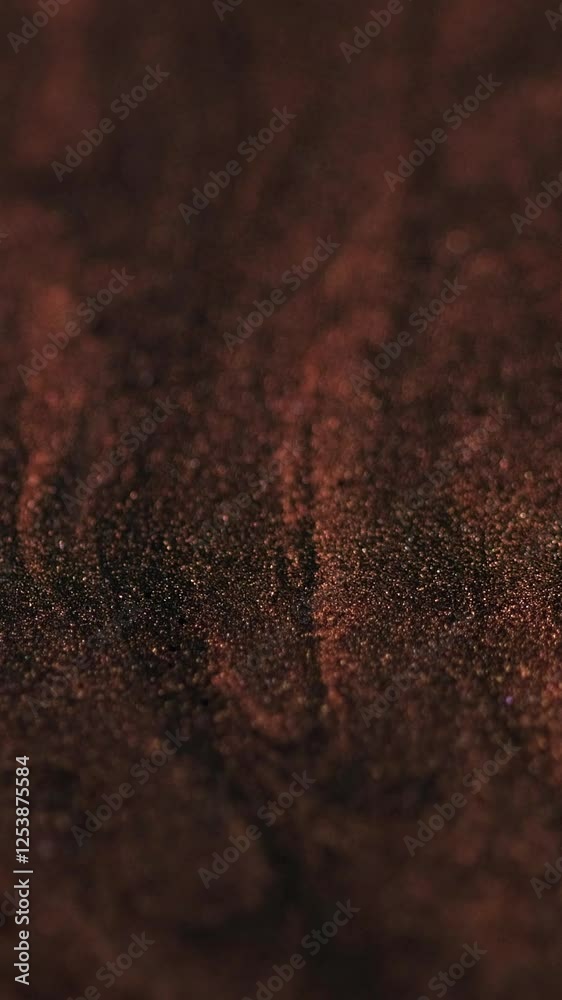 Vertical video. Glitter ink. Paint flow glow fluid. Defocused red shimmering brilliant gold color texture motion particles gel abstract background. Vertical video. Glitter ink. Paint flow glow fluid. Defocused red shimmering brilliant gold color texture motion particles gel abstract background.