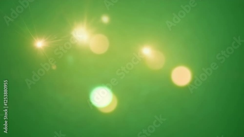 Bright pins of light dance playfully casting fleeting reflections on green. Green screen chromakey