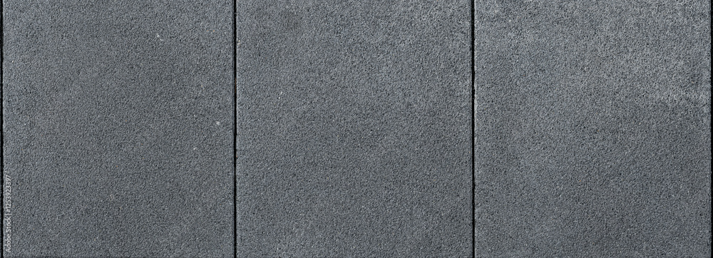 Fototapeta premium Close-up background of wall with dark gray cement panel texture and fine lines