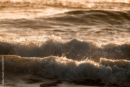 Fototapeta Naklejka Na Ścianę i Meble -  beautiful wave during sunset golden hour orange pretty ocean sea 
