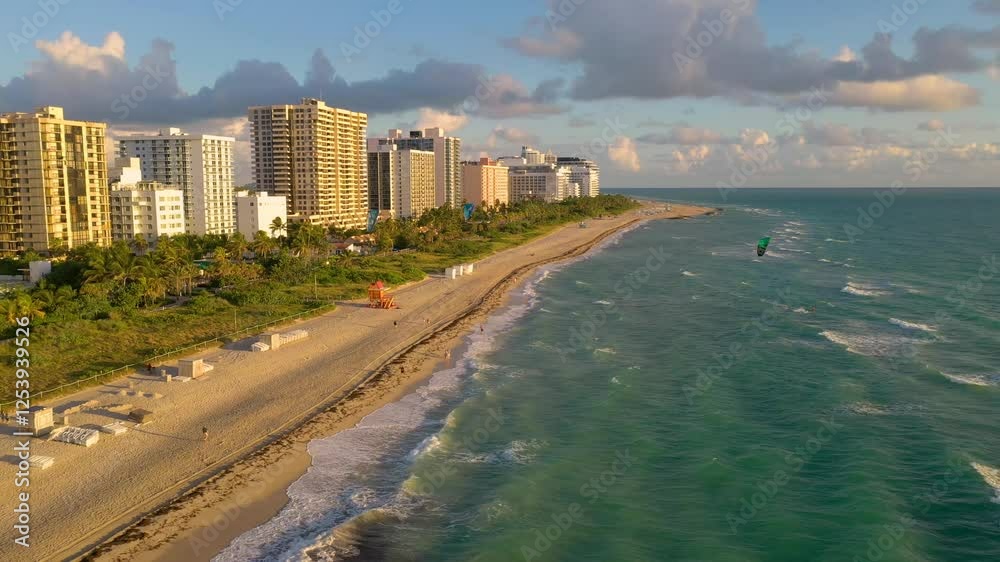 MIAMI, UNITED STATES - FEBRUARY 8, 2025: Scenic view of Miami beach with golden sands, tall buildings, and calm waters during sunset MIAMI, UNITED STATES - FEBRUARY 8, 2025: Scenic view of Miami beach with golden sands, tall buildings, and calm waters during sunset