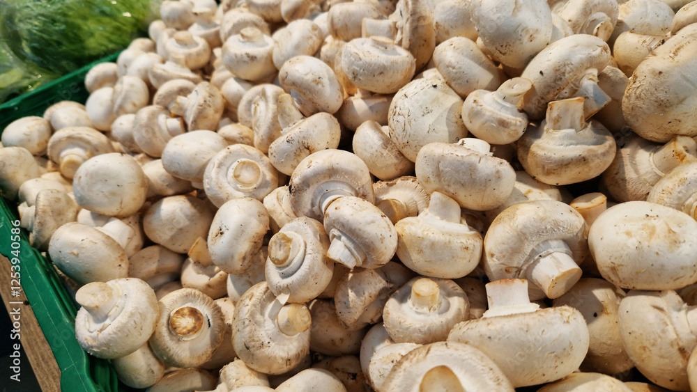Sale of champignons in a supermarket. Champignons in plastic boxes, close-up. Mushrooms in a store. A pile of champignons for sale at the market with selective focus Sale of champignons in a supermarket. Champignons in plastic boxes, close-up. Mushrooms in a store. A pile of champignons for sale at the market with selective focus