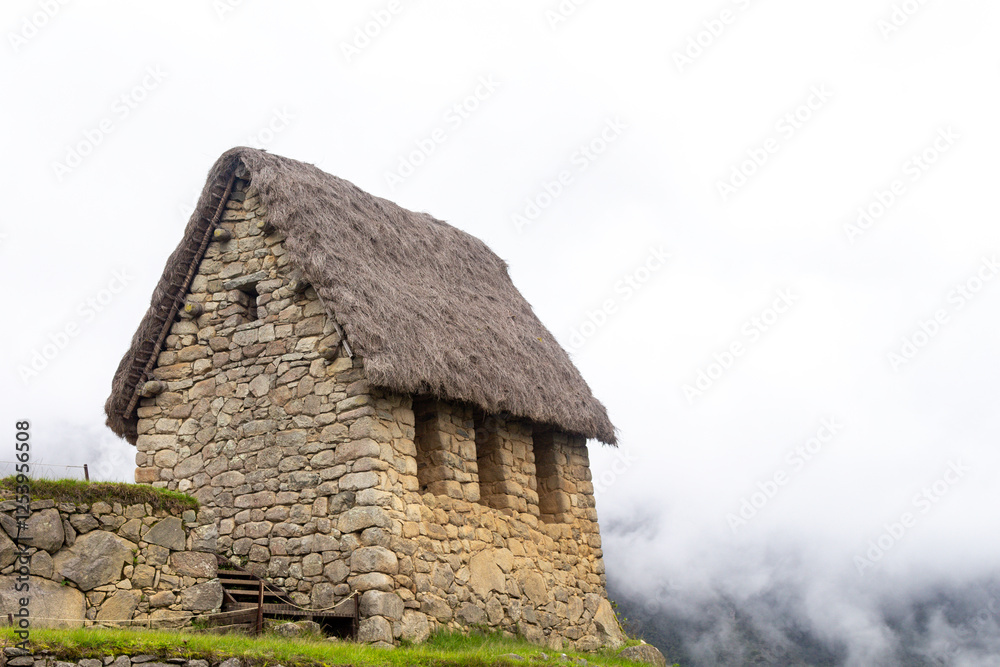 House of the Guardian, Inca construction in Machu-Picchu in Peru with clouds. House of the Guardian, Inca construction in Machu-Picchu in Peru with clouds.