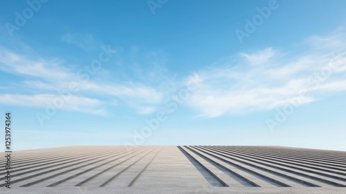 A serene landscape showcasing endless rows on a flat terrain beneath a clear blue sky with wispy clouds, exemplifying tranquility and minimalism in nature. photo