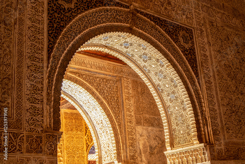 Intricate Moorish Arches Radiate before Alhambra’s Court of the Lions: A Sunlit Ode to Nasrid Legacy, Islamic Art, and Granada's Timeless Splendor photo