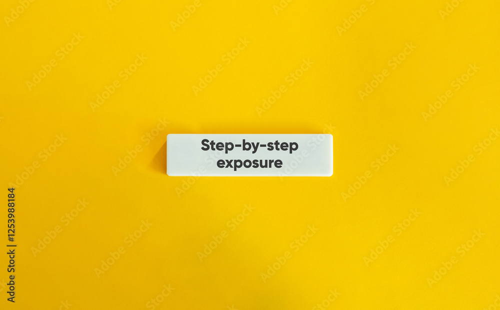 Step-by-step exposure, CBT. Text on Block Letter Tile on Yellow Background. Minimal Aesthetic. Step-by-step exposure, CBT. Text on Block Letter Tile on Yellow Background. Minimal Aesthetic.
