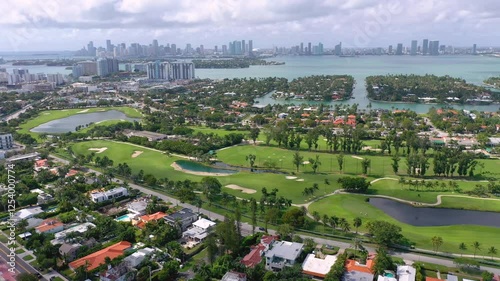 MIAMI, UNITED STATES - FEBRUARY 8, 2025: Aerial view of Miami skyline with lush green golf courses and waterfront properties