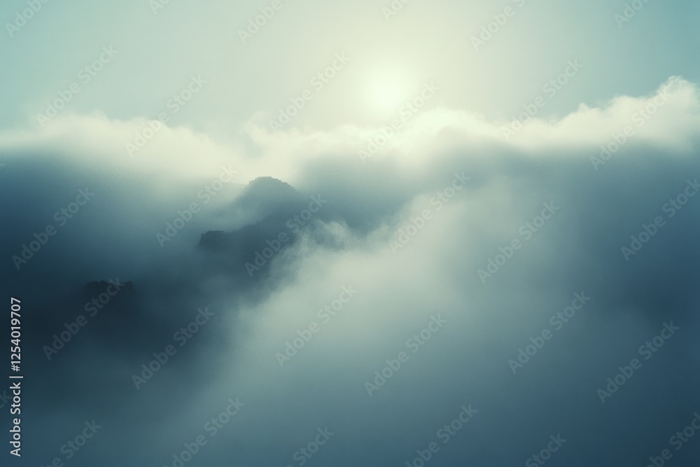 Fototapeta premium Sun peeks through clouds, creating a dreamlike scene of mountains and mist, capturing nature's beauty in ethereal hues.