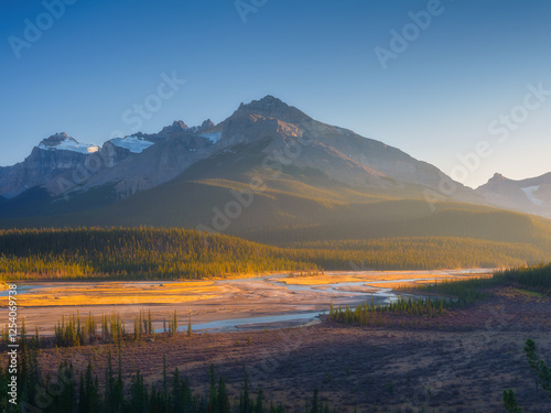 Nature. River and high peaks in a mountain valley at dawn. Mountain landscape...