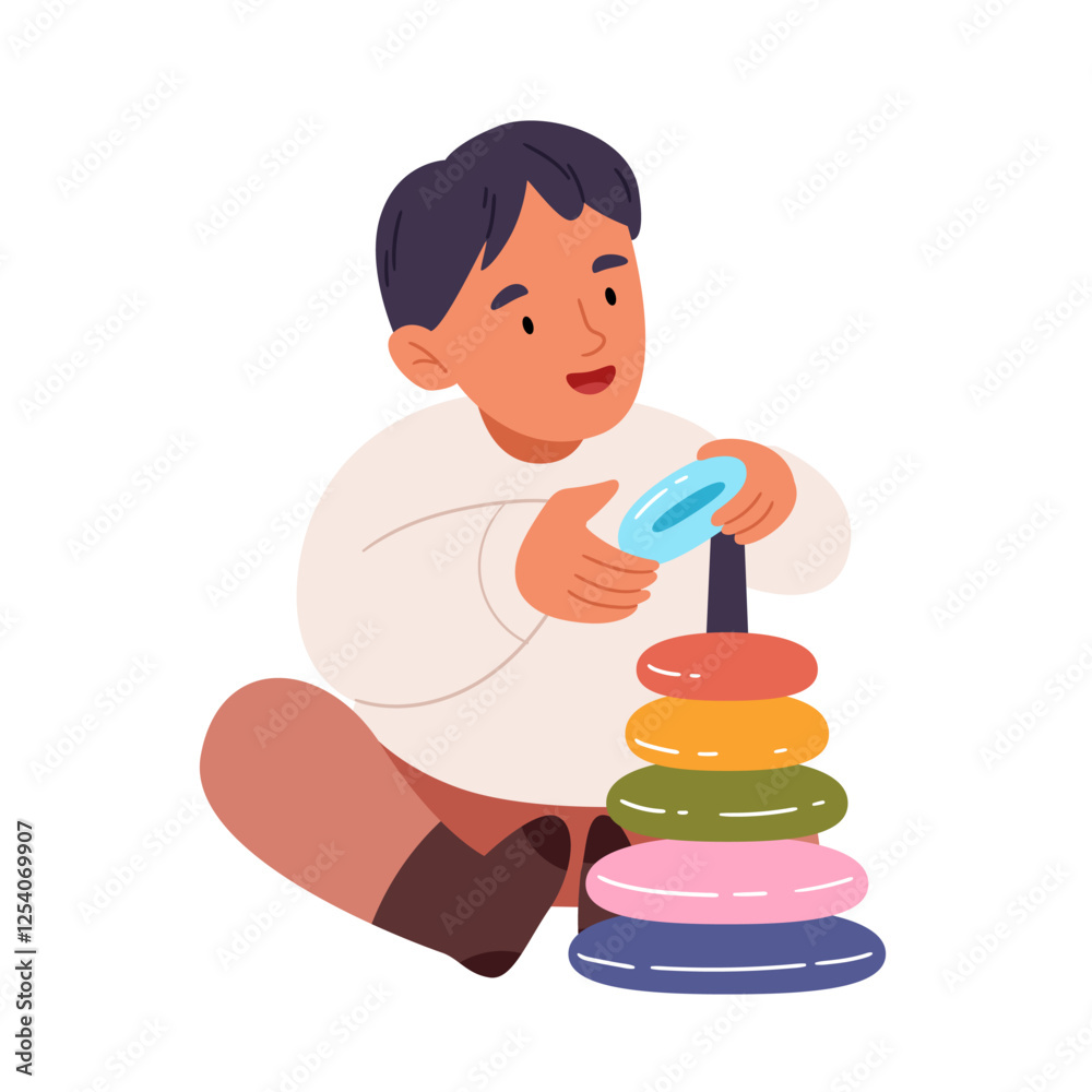 A child builds a toy pyramid.Cheerful child play educational game. A child builds a toy pyramid.Cheerful child play educational game.