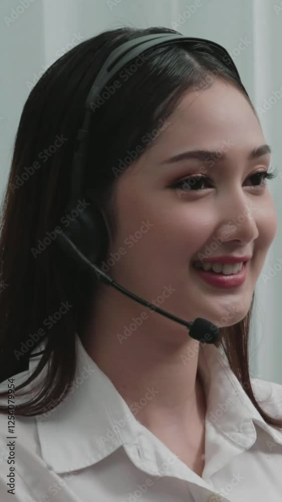 Asian customer support operator wearing headset and microphone working at her desk with laptop. Enthusiastic female employee provide customer service, supportive call center agent helping customers. Asian customer support operator wearing headset and microphone working at her desk with laptop. Enthusiastic female employee provide customer service, supportive call center agent helping customers.