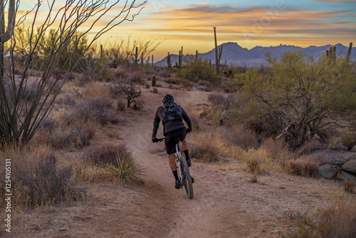 Man Riding Mountain Bike On Desert Trail In Arizona Right Before Sunrise 