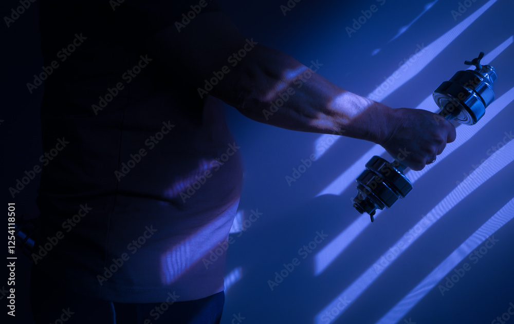Overweight person lifting dumbbell in dramatic blue light