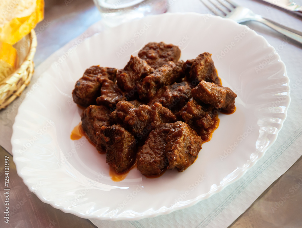 Appetizing veal stewed with sauce served on white plate Appetizing veal stewed with sauce served on white plate