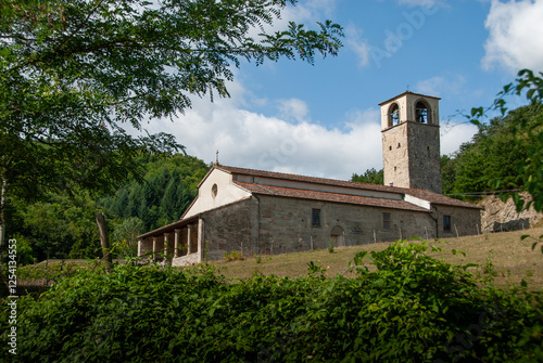 A beautiful church at the foot of the hills in Tuscany. In the town of Cornacchiaia, in Firenzuola, Florence, Italy. it is a thousand years oldand is in the middle of a leafy forest