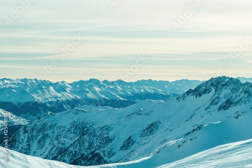 Majestic Snow-Covered Mountain Range Underneath Serene Sky at Dawn