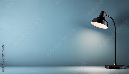 Sleek black desk lamp shedding soft light on a smooth blue wall, emphasizing a contemporary office environment. Blank background invites custom designs or text.