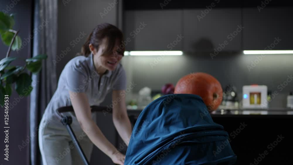 A woman engages with a bowling ball inside a stroller, creating a blend of reality and absurdity in her actions