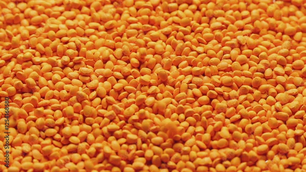 Orange polymer dye in granules, background texture Orange polymer dye in granules, background texture