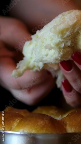 Hands tearing breaking apart fresh Baked crispy loaf of Bread, Close Up, bakery shop