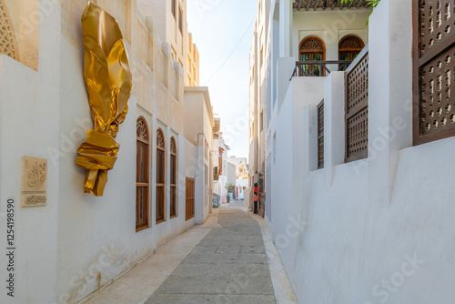 Ornate designs and architecture along the narrow whitewashed alleys of the Bahrian Pearling Path Old Town district, a cultural heritage site in Muharraq, Bahrain.