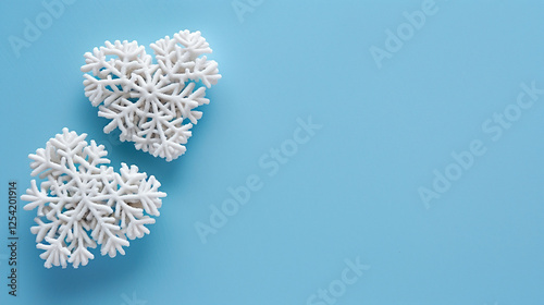 Snowflake Hearts on Blue Background: Winter Valentine’s Theme. White snowflake-patterned hearts with icy textures on a light blue background, great for holiday seasonal design. Blank area for text