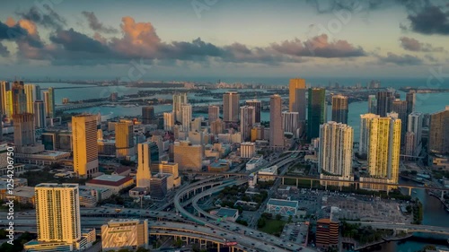 MIAMI, UNITED STATES - FEBRUARY 8, 2025: Stunning aerial view showcases Miami skyline bathed in golden sunlight during sunset