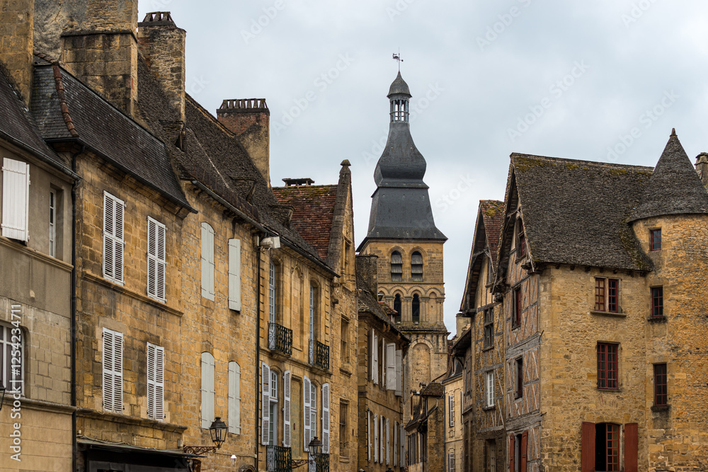 Exploring the medieval streets of Sarlat-la-Caneda under a cloudy sky Exploring the medieval streets of Sarlat-la-Caneda under a cloudy sky
